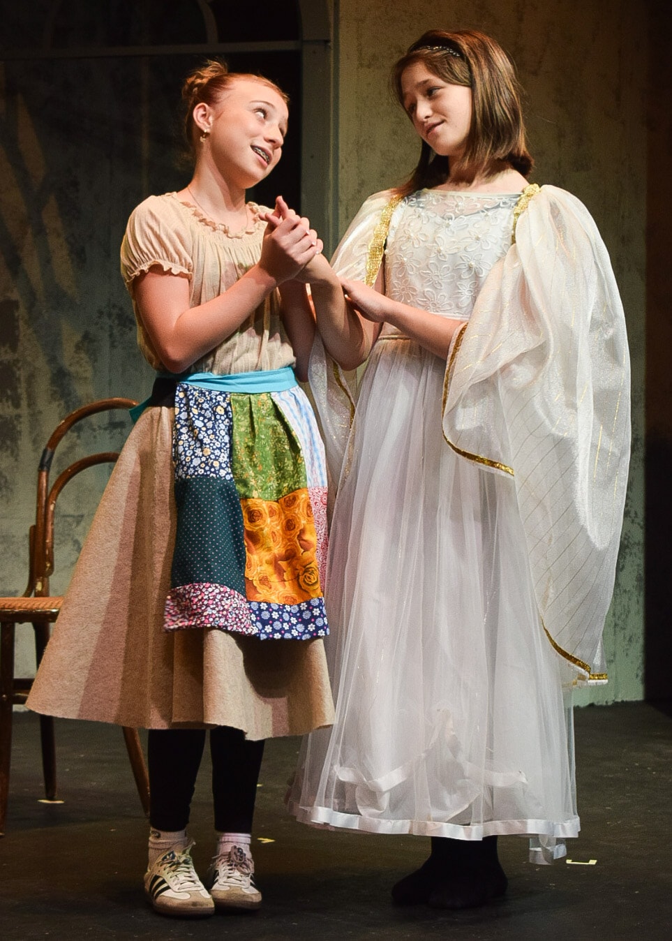 Two young performers on stage in costume